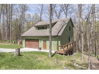 Charming home with a garage, inviting deck and surrounded by a beautiful, wooded area at 1032 E Woodall Ct, Martinsville, IN 46151