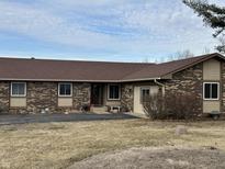 This charming single-story home features brick accents and a well-manicured lawn at 1130 W State Road 42, Mooresville, IN 46158