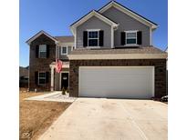 Beautiful two-story home with brick and siding, attached garage, and well-maintained lawn under a clear, sunny sky at 1456 Bigleaf Dr, Sheridan, IN 46069