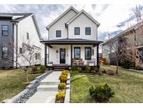 Charming two-story home featuring a welcoming front porch and meticulously landscaped front yard at 1947 Alvord St, Indianapolis, IN 46202
