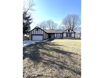 Charming home with a stone and tudor facade, set on a lush green lawn with mature trees at 2284 Horizon Blvd, Greenwood, IN 46143