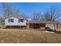 Charming two-story home featuring brick and siding accents, an attached garage, and a well-maintained front yard at 24535 Jerkwater Rd, Sheridan, IN 46069