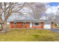 Charming brick ranch home with an attached garage and a well-maintained front yard at 3345 Central Ave, Columbus, IN 47203