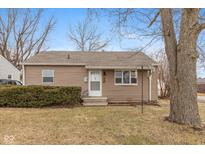 Charming single-story home with a well-maintained lawn and mature landscaping at 401 N 15Th Ave, Beech Grove, IN 46107