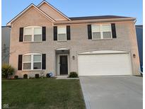 Charming two-story brick home with attached two-car garage and well-manicured lawn at 4067 Denali Dr, Indianapolis, IN 46235