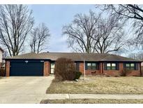 Charming brick single-story home featuring attached garage, manicured lawn, and well-maintained landscaping at 429 Southmore St, Plainfield, IN 46168
