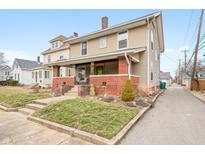 Charming two-story home with a inviting front porch, brick accents, and well-maintained lawn at 448 E Madison St, Franklin, IN 46131