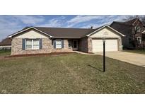 Charming single-story brick home with a two-car garage and well-maintained front lawn at 4946 Kilda Dr, Greenwood, IN 46142