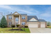 Charming brick two-story home with a three-car garage and well-maintained landscaping at 538 Cyclamen Chase, Westfield, IN 46074