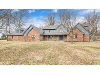 Charming brick home featuring blue wood accents, dormers, and a well-manicured lawn on a sunny day at 690 N 600 W, Lebanon, IN 46052