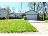 Charming one-story home with a well-maintained lawn and attached two-car garage at 7101 Thousand Oaks Ln, Indianapolis, IN 46214