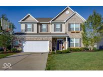 Charming two-story home with a well-maintained lawn, attached two-car garage, and beautiful brick and siding facade at 8416 Whitaker Valley Blvd, Indianapolis, IN 46237