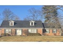 Charming single-story brick home with dormer windows, shutters, well-manicured lawn, and a classic double door entry at 8888 Cholla Rd, Indianapolis, IN 46240