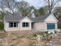 Charming brick home with gray roof, teal shutters, and a teal garage door at 103 N Brenrich Rd, Pendleton, IN 46064