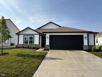 Charming single-story home with a well-manicured lawn, black trim, and black garage door at 1414 Bluebonnet Pl, Shelbyville, IN 46176
