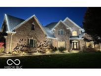 Festive brick home exterior adorned with charming holiday lighting at dusk at 154 Woodfield, Danville, IN 46122
