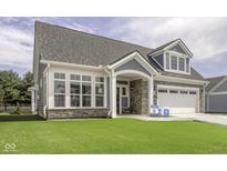 Charming home featuring stone accents, a manicured lawn, and a two-car garage at 16822 Imperial Ct, Fishers, IN 46040