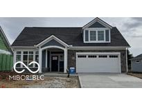 Beautiful new construction home featuring stone accents, a two-car garage and a covered entry way at 16822 Imperial Ct, Fishers, IN 46040