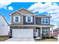 Charming two-story home with a stone-accented facade, two-car garage, and well-manicured landscaping at 1835 Fairmount Dr, Greenfield, IN 46140