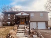 Charming two-story home featuring a welcoming porch and attached two car garage at 2317 Lincoln Dr, Cicero, IN 46034