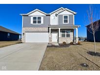 Charming two-story home featuring a stone facade, gray siding, well-manicured lawn, and a convenient two-car garage at 2976 W Tapestry Dr, Monrovia, IN 46157