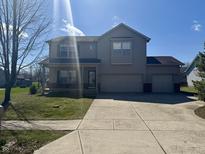 Charming two-story home with a two-car garage and manicured lawn at 307 Blue Spruce Dr, Pendleton, IN 46064