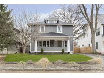 Charming two-story home featuring a covered front porch and professionally landscaped front yard at 4317 N Park Ave, Indianapolis, IN 46205