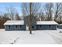 Charming blue home featuring a metal roof and a snowy front yard at 6205 Beech Grove Rd, Martinsville, IN 46151