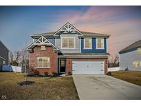 Attractive two-story home with brick accents, a two-car garage, and a well-maintained lawn at 8148 Ebaugh Dr, Camby, IN 46113