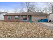 Charming single-story home with a brick facade and an attached garage at 817 Delray Dr, Indianapolis, IN 46241