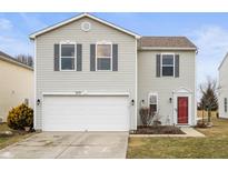 Charming two-story home with a two-car garage, gray siding, dark shutters, and red front door at 9698 W Lantern Ln, Pendleton, IN 46064