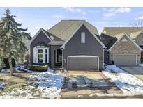 Charming brick home featuring a two-car garage, a well-manicured lawn, and a classic architectural design at 11338 Bayhill Way, Indianapolis, IN 46236