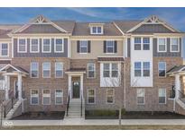 Inviting brick and siding townhome with meticulously maintained landscaping and a welcoming front entrance at 1208 Chapman Dr, Westfield, IN 46074