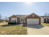 Charming brick home featuring an attached two-car garage and manicured front lawn at 12329 Wolf Run Rd, Noblesville, IN 46060