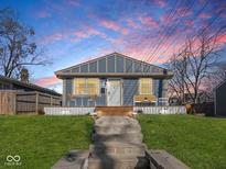 Charming bungalow with a welcoming front porch and well-maintained lawn at 1420 E Market St, Indianapolis, IN 46201