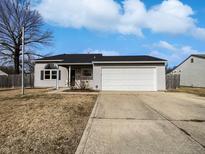 Charming single-story home featuring a spacious two-car garage and a well-manicured front yard, perfect for Gathering living at 1492 Michigan Rd, Franklin, IN 46131