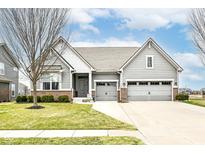 Charming two-story home featuring a manicured lawn, neutral siding, and an attached two-car garage on a sunny day at 15949 Foothill Dr, Noblesville, IN 46060