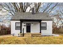 Charming home featuring a gray roof, black trim, and a cozy front porch perfect for relaxing at 1912 Glenridge Dr, Indianapolis, IN 46218