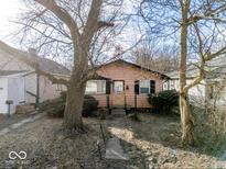 Charming single-story home with a cozy front yard and mature trees at 3106 N Harding St, Indianapolis, IN 46208