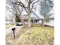 Charming two-story home with a quaint front porch and an expansive front yard at 3209 Bethel Ave, Indianapolis, IN 46203