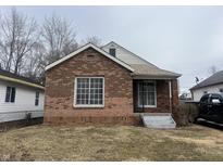Charming brick home with a cozy front porch and well-maintained landscaping at 3451 Brouse Ave, Indianapolis, IN 46218