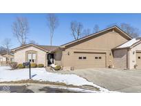 Charming brick and siding home with an attached two-car garage and well-maintained landscaping at 3636 Woodglen Way, Anderson, IN 46011
