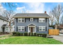 Charming two-story home featuring a well-maintained lawn and classic architectural details at 4517 Central Ave, Indianapolis, IN 46205