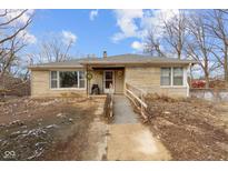Charming ranch-style home featuring stone exterior, accessible ramp, and inviting front porch at 6270 Clydes Rd, Indianapolis, IN 46268