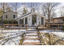 Charming exterior featuring a white brick facade, large windows, and a spacious deck with a pergola at 7890 Laurel Dr, Nineveh, IN 46164