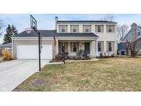 Charming two-story home features a brick facade, attached garage, and front porch with swing at 803 Hickory Way, Noblesville, IN 46062