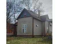 Charming two-story home featuring classic architecture and a well-maintained exterior with a chimney at 817 W 5Th St, Anderson, IN 46016