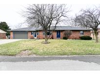 Charming single-story brick home featuring a well-maintained lawn and inviting facade at 8430 Lockwood Ln, Indianapolis, IN 46217