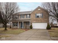 Charming two-story home with a two-car garage, brick accents, and blue shutters at 9078 N River Chase Ln, McCordsville, IN 46055