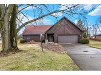 Charming home with wood siding, attached garage, and well-maintained front yard at 14304 Adios Pass, Carmel, IN 46032